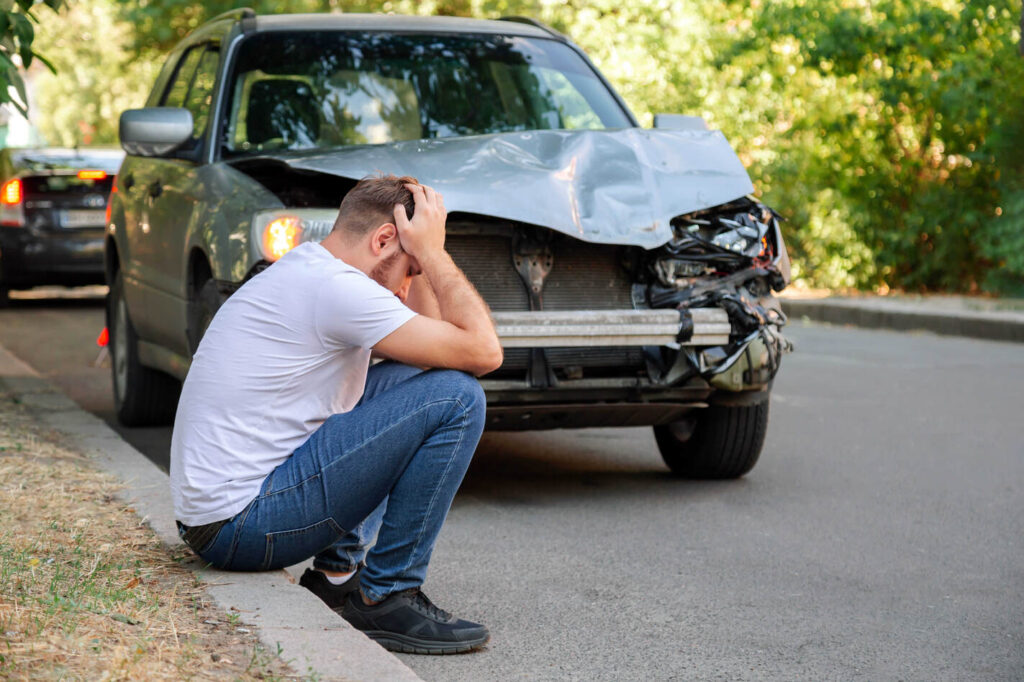 A person scared after an auto accident and unsure what to do