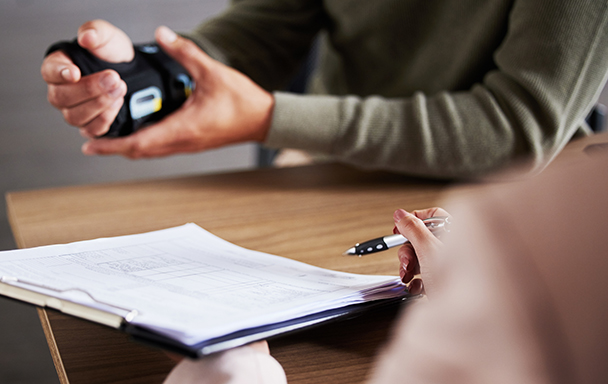 Man in a wrist guard after a workplace injury seeking a workers’ comp attorney

